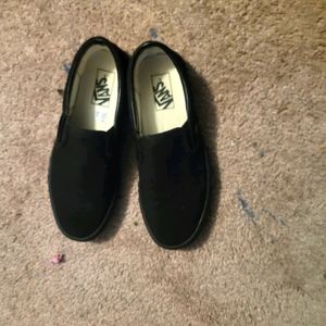 All black slip on vans